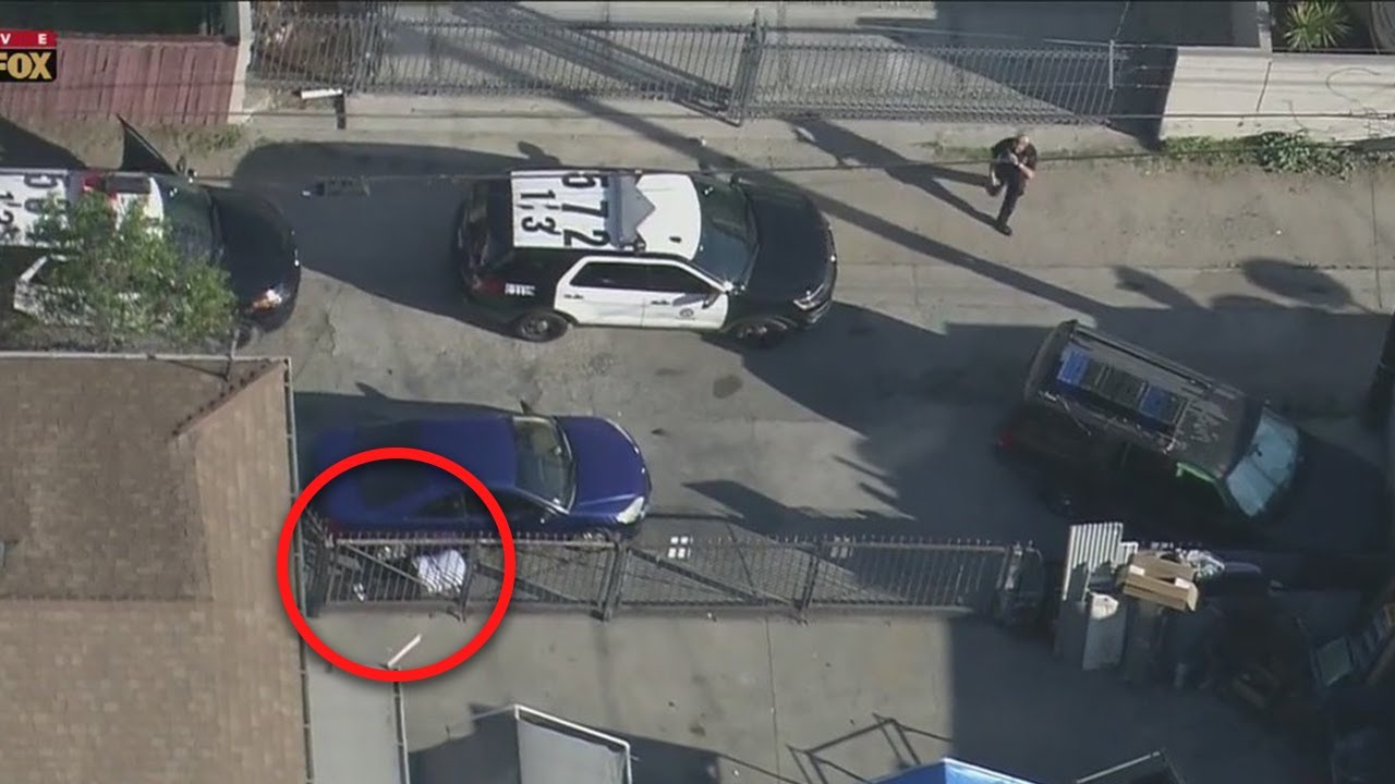 ‘Come on guys! He’s right there!’: Pursuit suspect tries to evade LAPD by laying next to vehicle